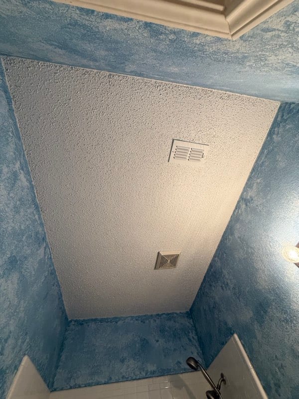 The same ceiling closed up and textured to match, both vents back in place