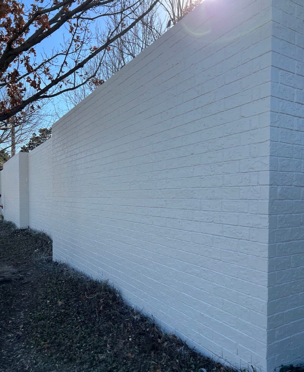 Brick perimeter wall painted white by Patch Plus Paint