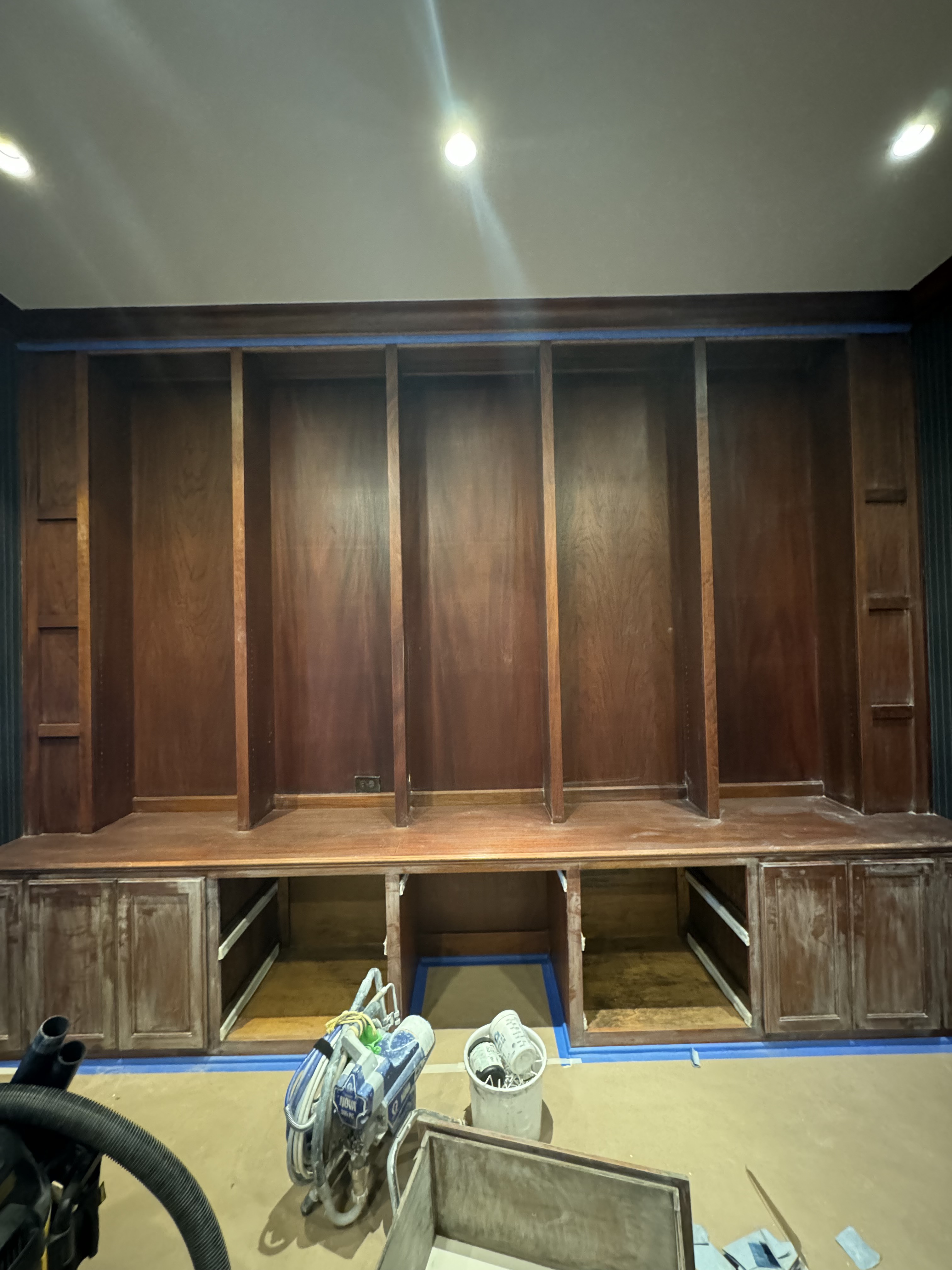 Built-in cabinets before painting — dark stained wood