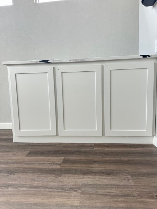 The same base cabinet after painting in a smooth white finish