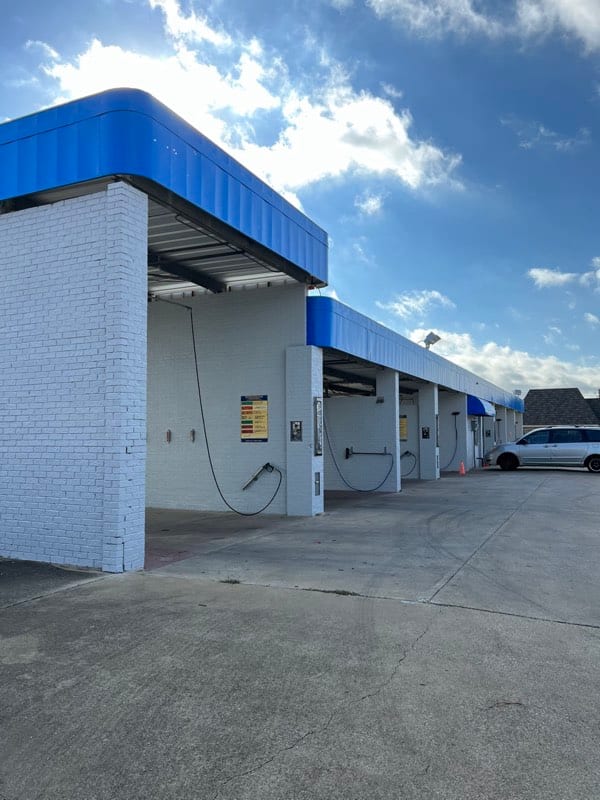 The same car wash with the brick painted white and the trim in bright blue