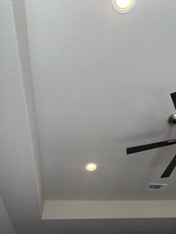 The finished ceiling with the texture matched and no sign of the repair