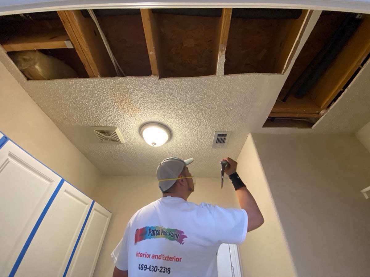 Patch Plus Paint crew member repairing a damaged ceiling in a North Dallas home