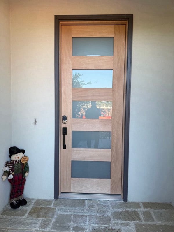 Modern front door in bare unfinished wood