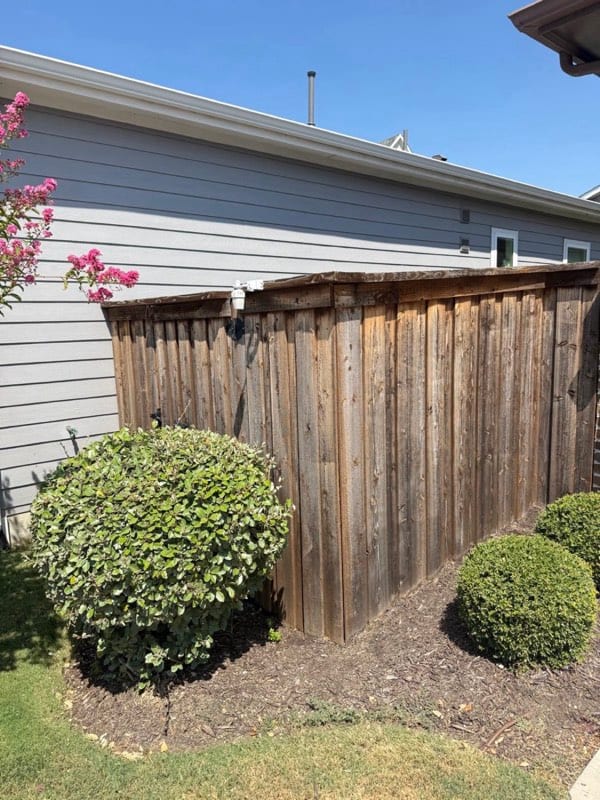 Weathered gray wooden fence before staining