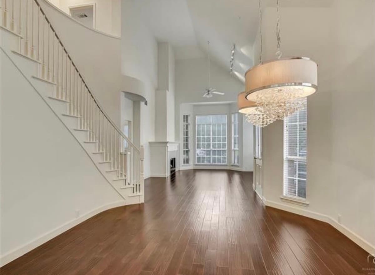 Two-story foyer with curved staircase after painting