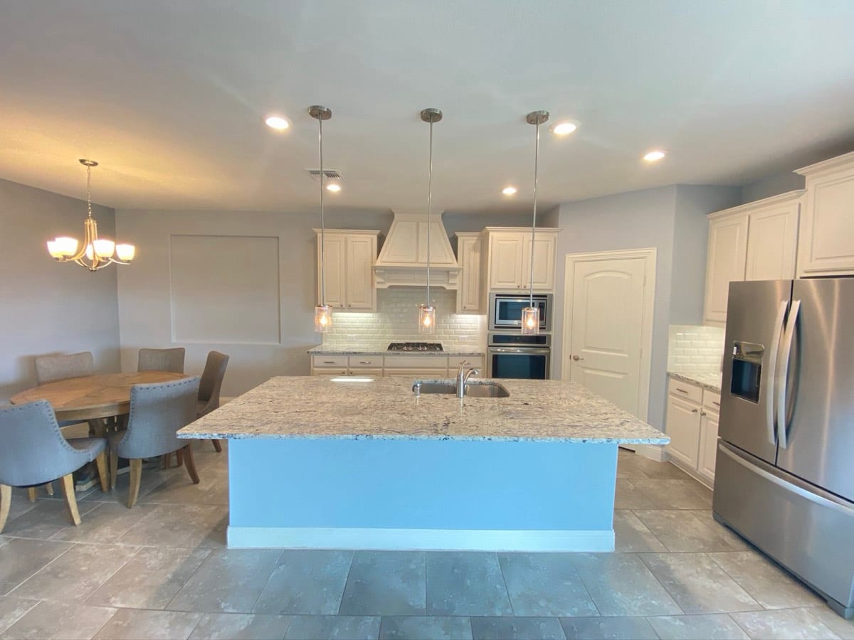 Freshly painted kitchen and dining area with cream cabinets