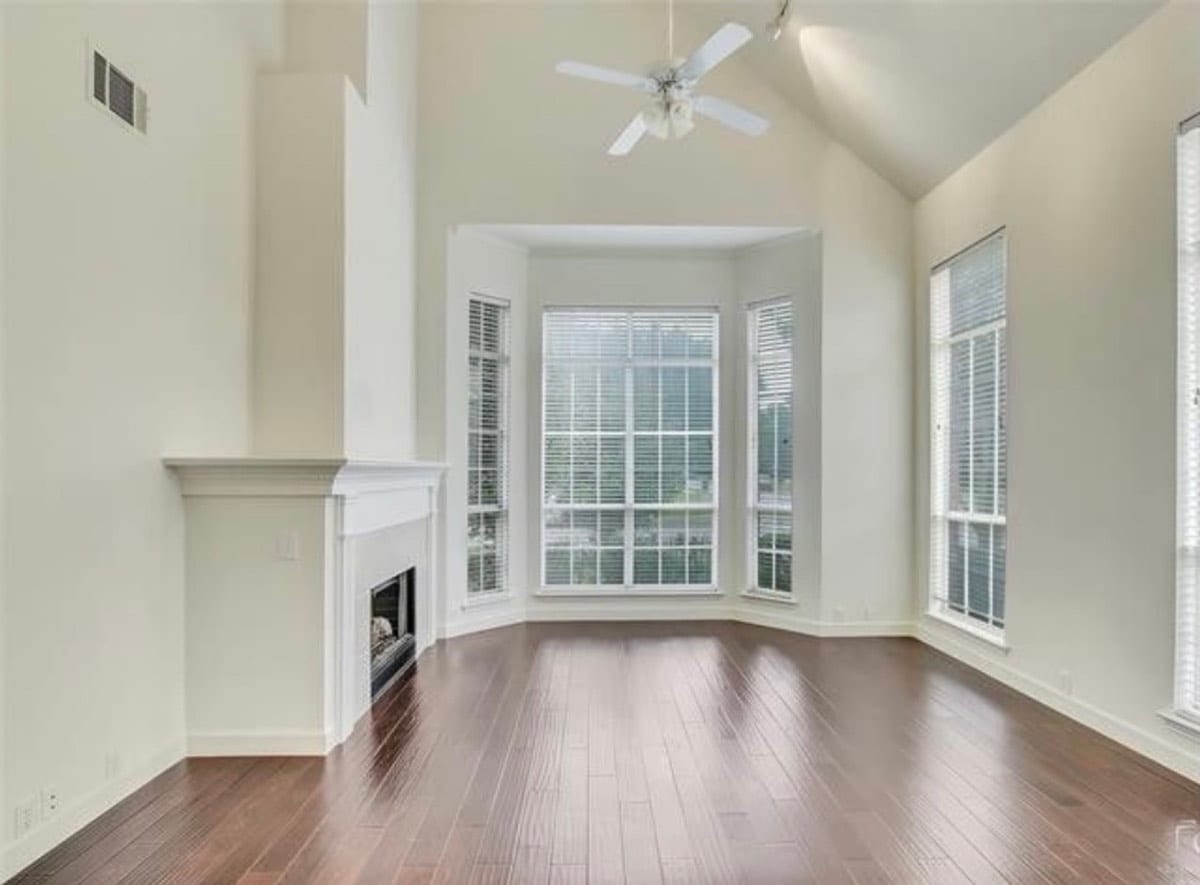 Living room with vaulted ceiling and bay window after painting