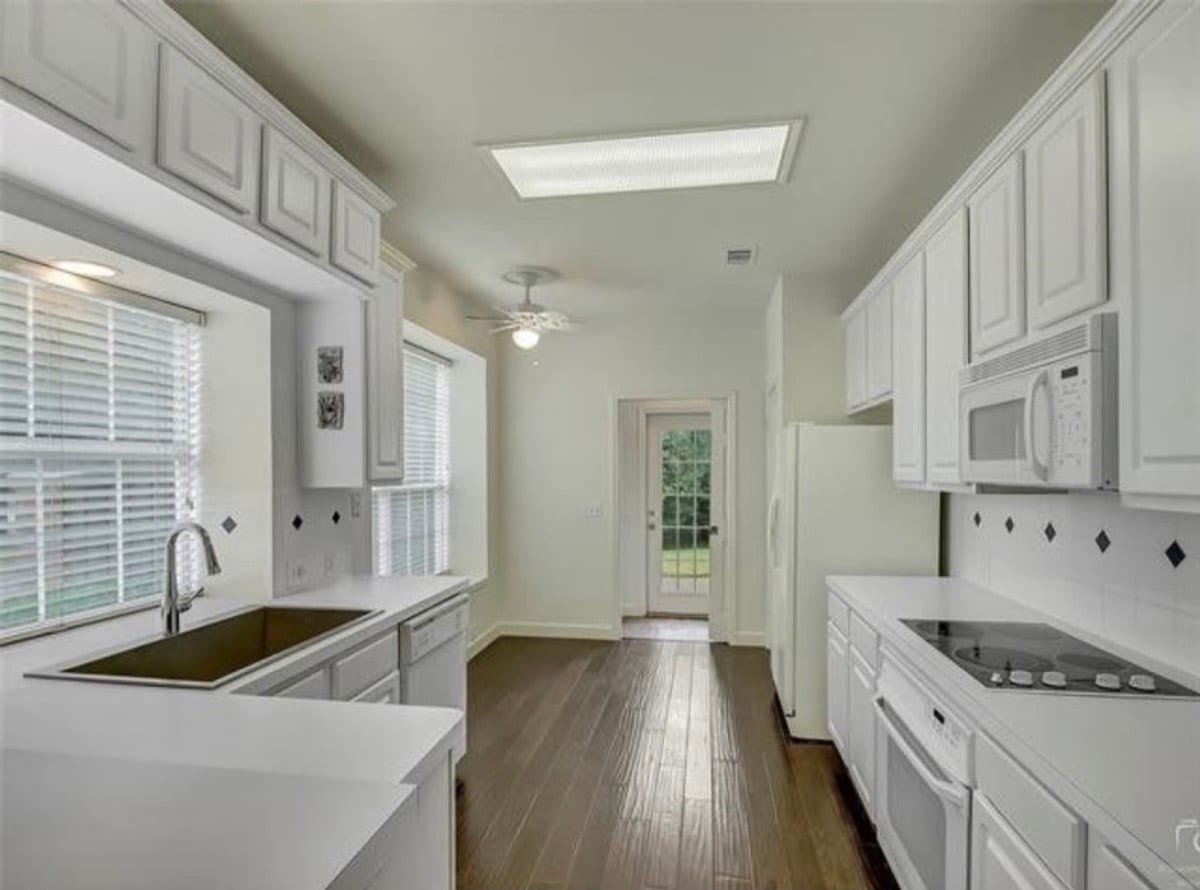 Galley kitchen with white painted cabinets