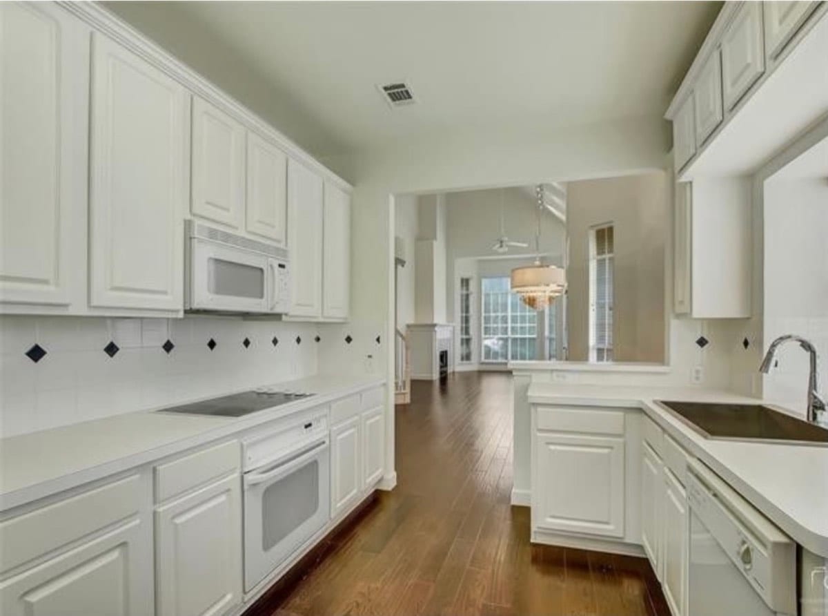 Kitchen with white painted cabinets
