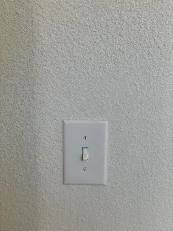 The finished wall with the switch plate back on and the texture matched