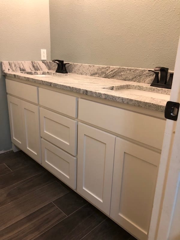 Same bathroom vanity after priming and painting the cabinets