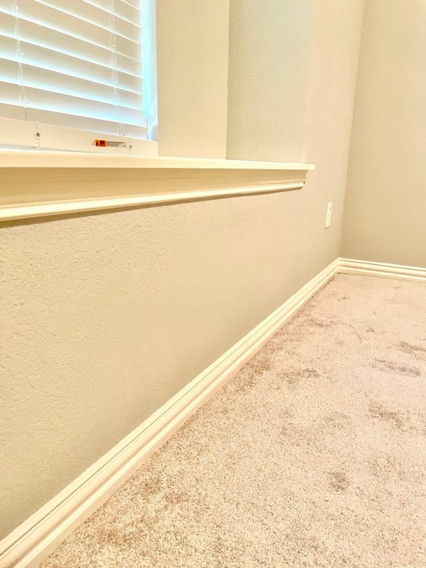 The same wall finished — textured, painted, and baseboard reinstalled